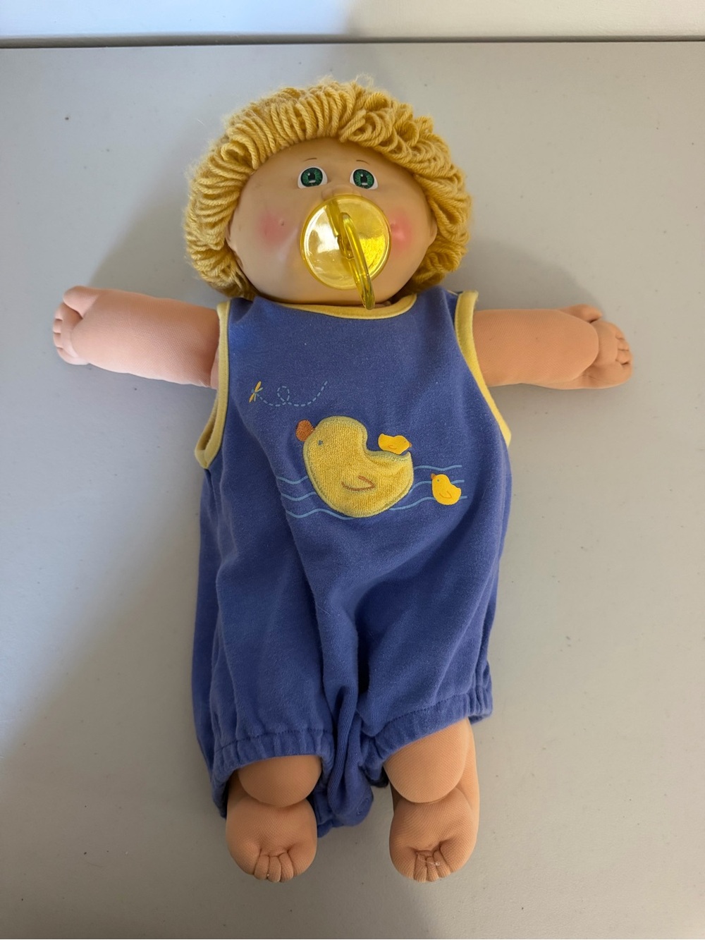 Soft Plush Baby Doll in Blue Romper with Yellow Pacifier